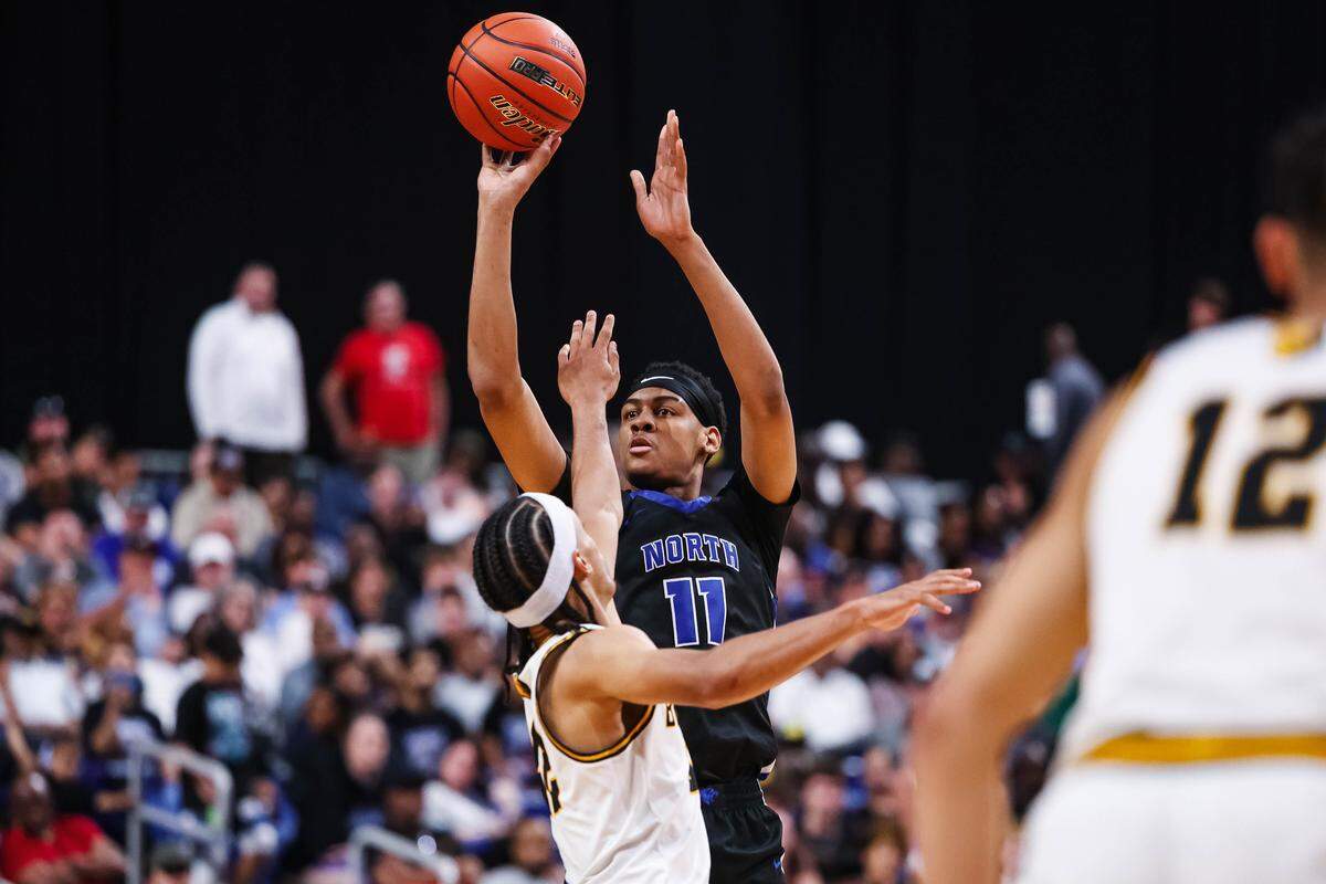 North Crowley forward Trey Hall (11) attempts a shot over a San Antonio Brennan defender in the Class 6A Division I state championship at The Alamodome in San Antonio, Texas, March 14, 2026.