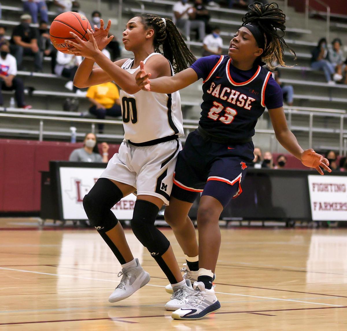 Mansfield post Zarria Carter (00) gets fouled by Sachse guard Crislyn Rose (23) during the second half of the 6A Region II Girls Basketball Area -Round 2 played February 23, 2021 at Lewisville High School. (Steve Nurenberg Special to the Star-Telegram)