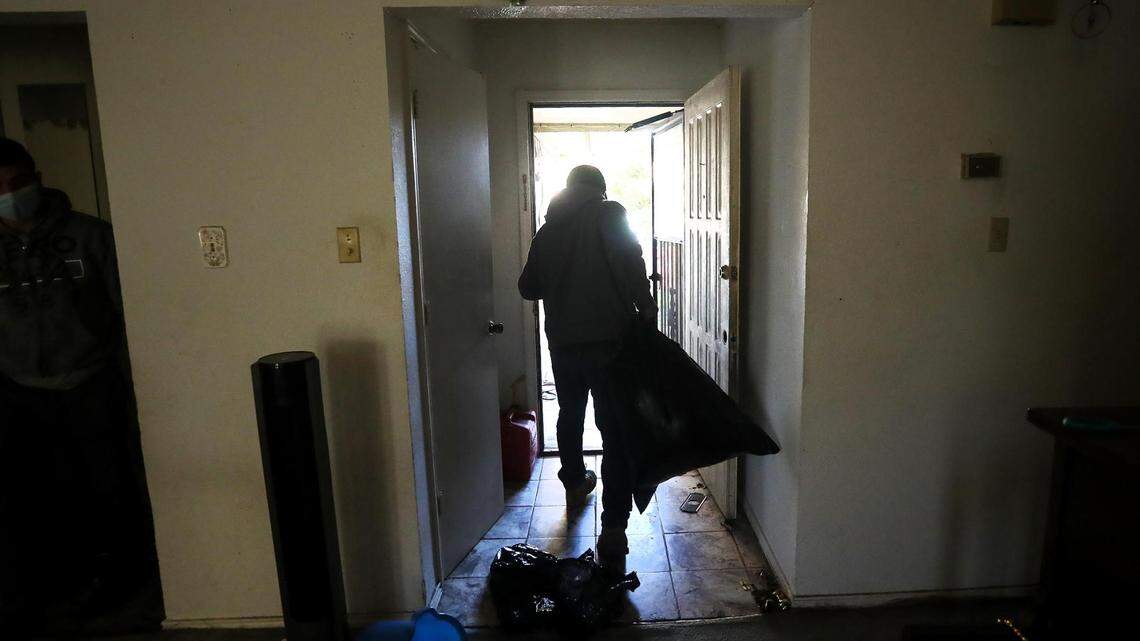 A crew removes the possessions of former tenants from a home in south Fort Worth after a writ of possession was served in February.