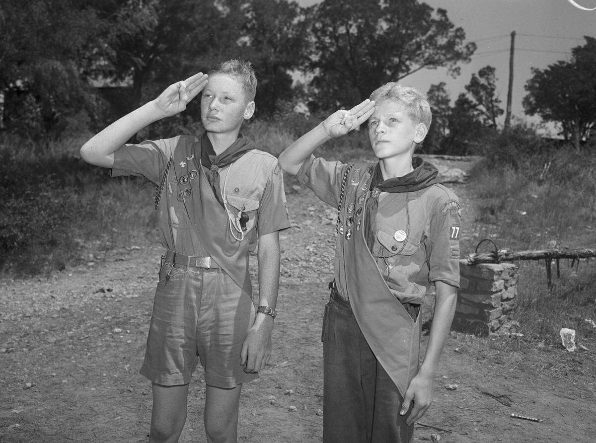 July 26, 1944: Saluting the flag at a retreat at Worth Ranch, Boy Scout camp near Palo Pinto, are Wayne Wilkins (left), son of Mr. and Mrs. Earl Wilkins and Fred Coffey Jr., son of Mr. and Mrs. Fred Coffey, all of Denton, Texas.