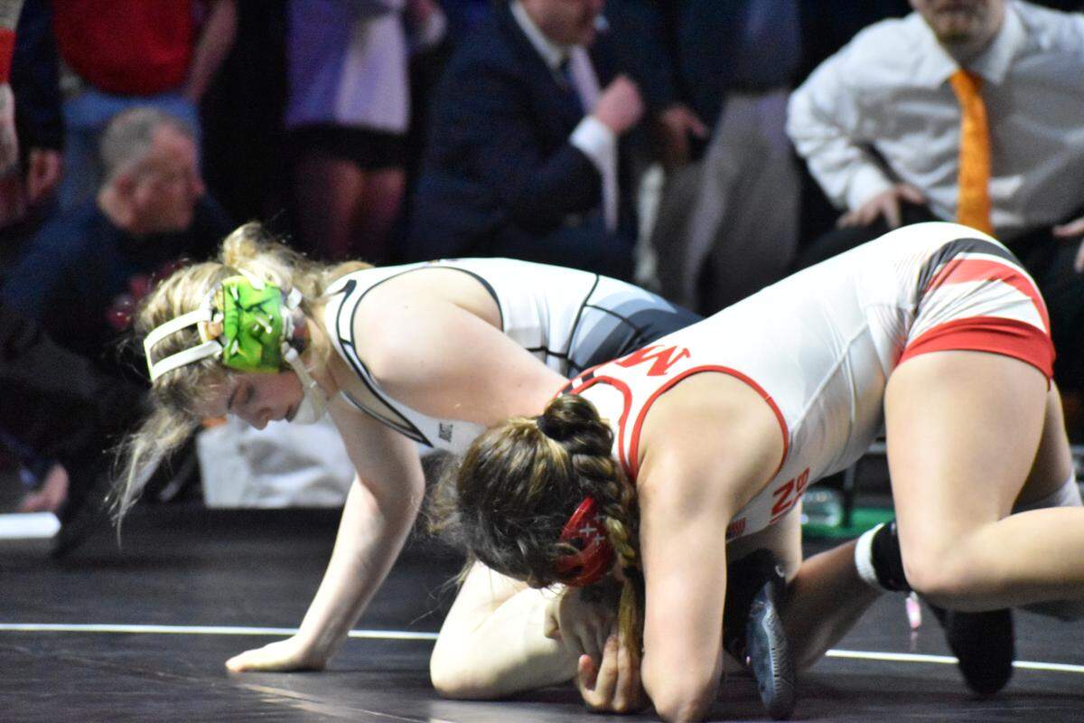 Arlington Martin wrestler Camille Rainey grabs ahold of her opponent at the UIL Texas high school wrestling state tournament in Cypress, Texas, on Saturday, Feb. 14, 2026.