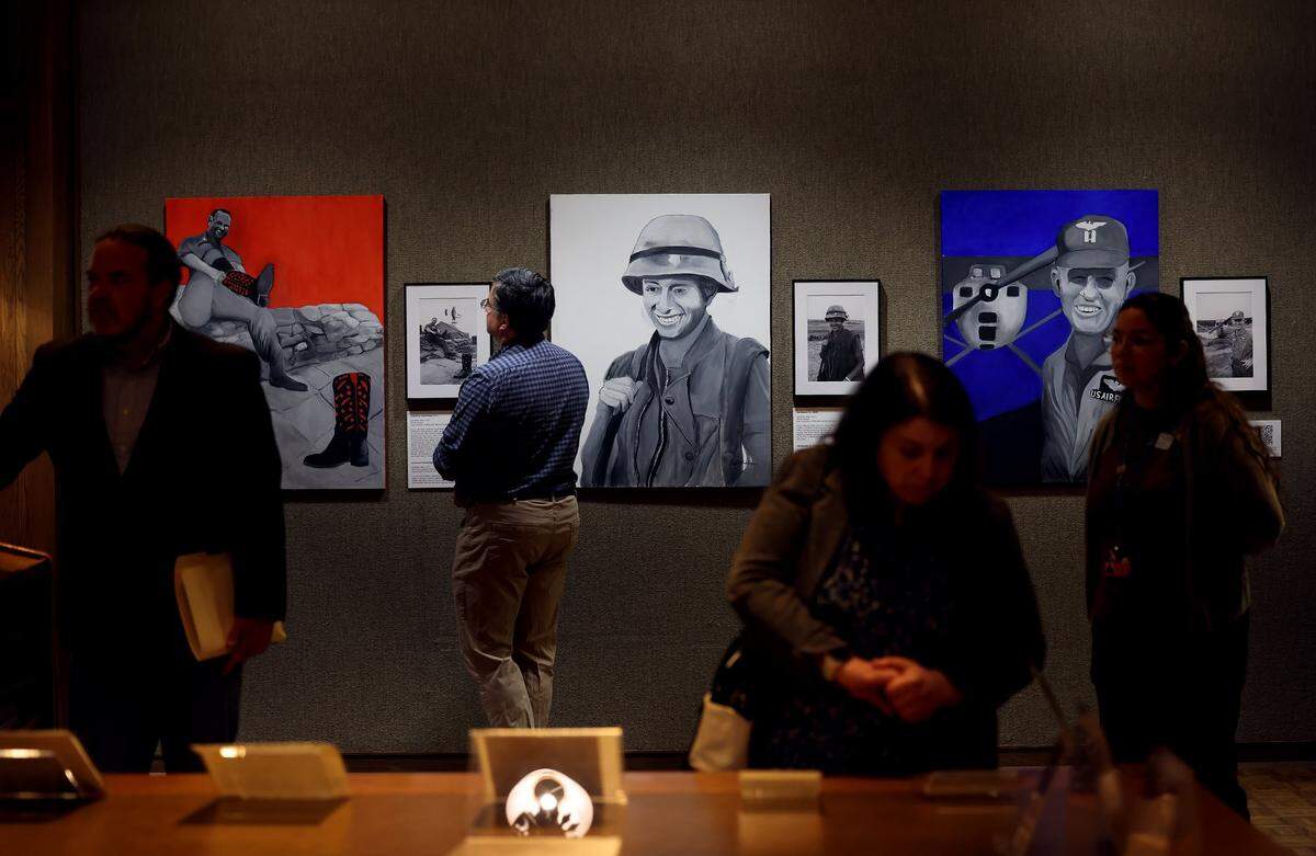 The public views the work of Bob Schieffer, who photographed the Vietnam War for the Fort Worth Star-Telegram, during the opening of the exhibit at UT Arlington on Monday, Feb. 9, 2026, at UT Arlington.