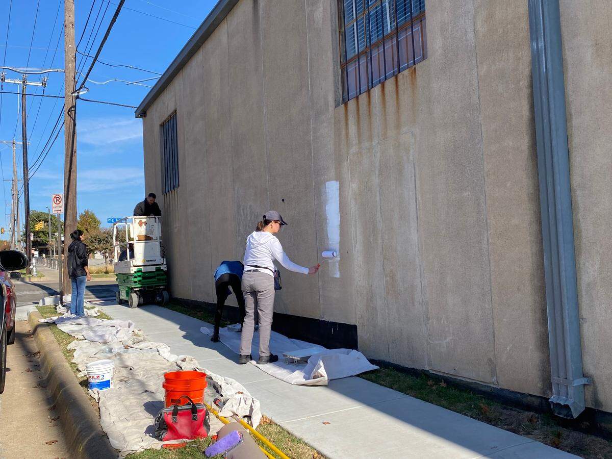 Anne Allen rolled her paint for a downtown mural.