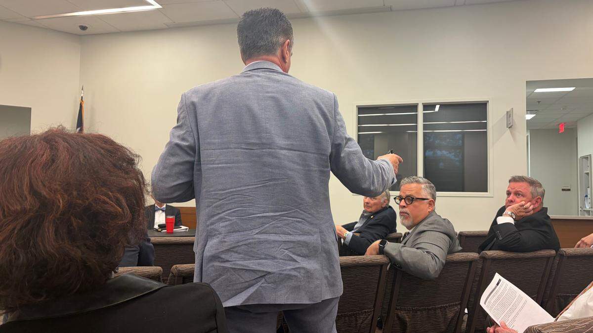 Brian Willett, standing, directs his public comments to County Judge Tim O’Hare, right, about his apparent removal from a list of court-appointed attorneys, during a Tarrant County Juvenile Board meeting Wednesday.