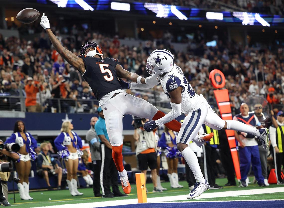 Cincinnati Bengals wide receiver Tee Higgins reaches for the ball while covered by Dallas Cowboys cornerback DaRon Bland on Monday, Dec. 9, 2024, at AT&T Stadium in Arlington.