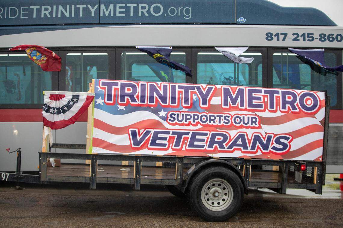 A Trinity Metro bus lines up to enter the parade for Veterans Day in Fort Worth on Friday, Nov. 11, 2022. Despite rain, hundreds of participants marched down North Forest Park Boulevard, waving American flags and signing a medley of military songs.