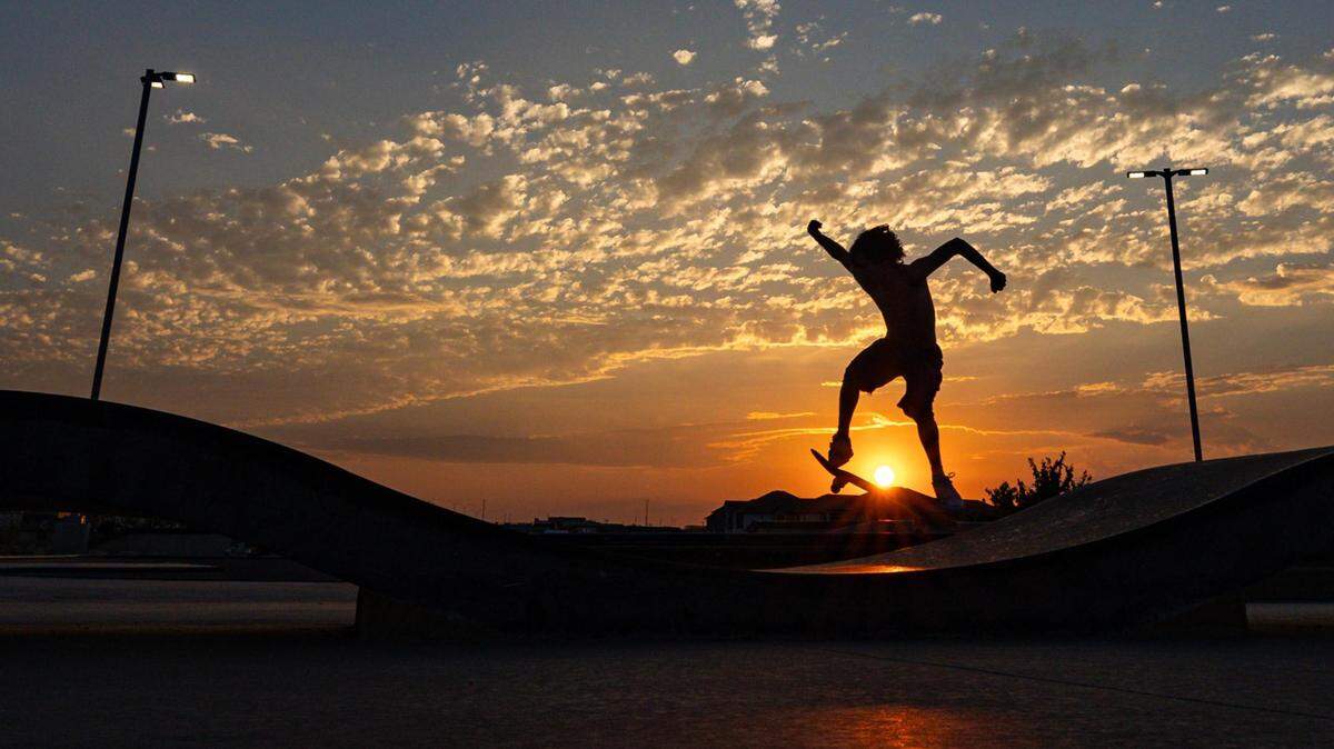 Ramsey Rivera skates up a slope at sunset at Chisholm Trail Skate Park in Fort Worth on Tuesday, Aug. 29, 2023.