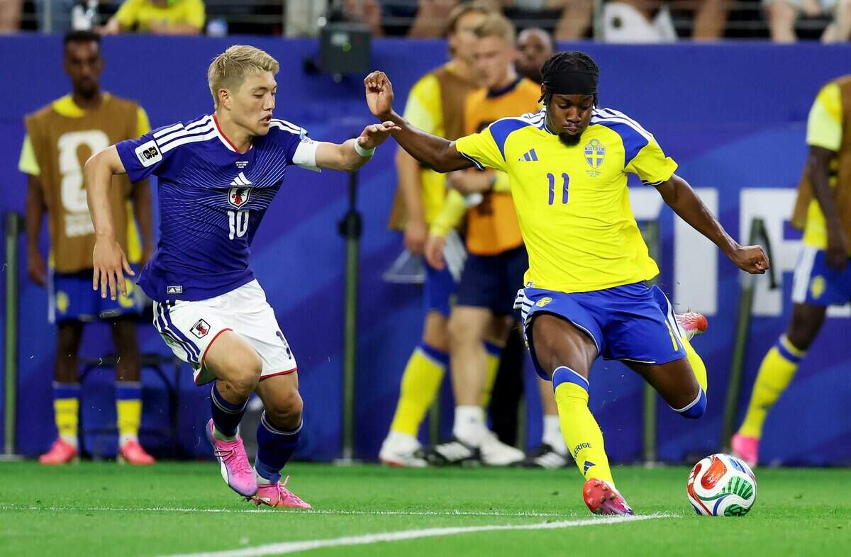 Sweden forward Anthony Elanga takes a shot while defended by Japan midfielder Ritsu Doan during the FIFA World Cup 2026 group stage match on Thursday, June 25, 2026, at Dallas Stadium in Arlington. Elanga scored to tie Japan, 1-1.