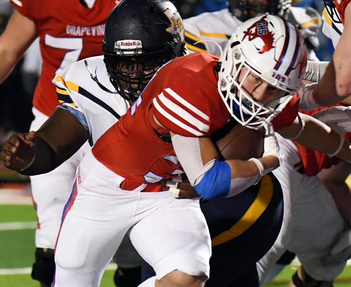 Grapevine’s Reid Watkins center gets into the end zone past Arlington Heights’ Jesse Gaytan, left, to take a 28-0 lead in the fourth quarter of Friday’s October 28, 2022 District 4-5A Division 2 football game at Mustang-Panther Stadium in Grapevine, Texas. Special/Bob Haynes