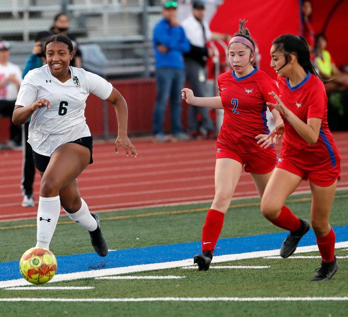 Kennedale’s Jada Shaw (6) brings the ball down the sidelines in front of Carter Riverside’s Mairely Galvan (2) and Destiney Pena (9) during a 4A Region 1 bi-district girls soccer playoff game at Elk Stadium in Burleson, Texas, Friday, Mar. 25, 2022. Kennedale moves on after defeating Carter Riverside 5-1. (Special to the Star-Telegram Bob Booth)