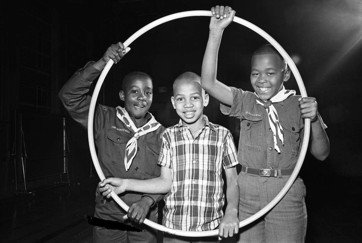 A group of Cub Scouts from Cub Scout Pack 231, represented by Kirkpatrick Elementary school students Dale Brown, 10, Anthony Earle, 9, and Marcus Jones, 9, who won the hula hoop race at the 1968 Cub Scout Olympics. The event was held by the Woodbine Trail District Longhorn Council of the Boy Scouts which took place in Harmon Recreation Center in Fort Worth and was attended by about 100 Cub and Boy Scouts.
