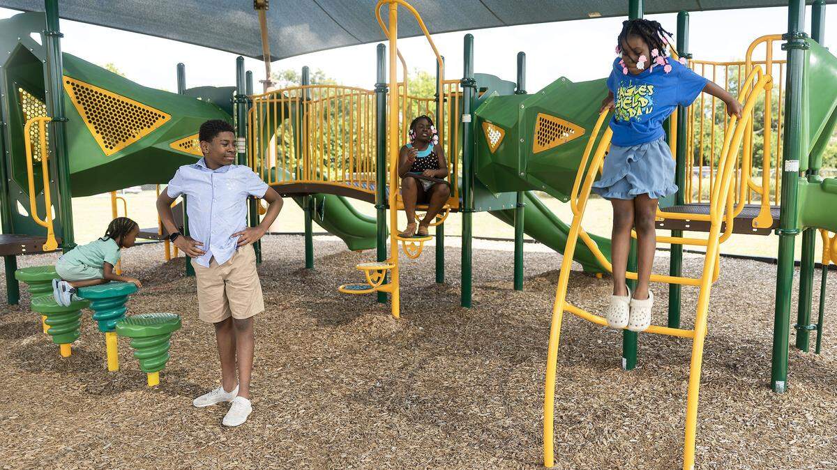 Siblings Gabriel, 4, left, Deshawn, 13, second from left, Moriah, 10, second from right, and Aniyah Lomax, 8, right, play together on the playground next to Briscoe Elementary School. Playgrounds like this helped the Fort Worth jump in an annual ranking of the city’s park system. 