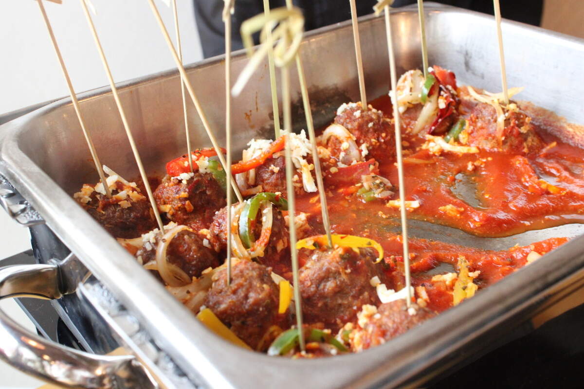 Albondingas, or meatballs, with chipotle pepper ranchera salsa, cojita, black beans, and rice at West + Stone, Sheraton’s new restaurant bar. Tuesday, April, 23, 2024.