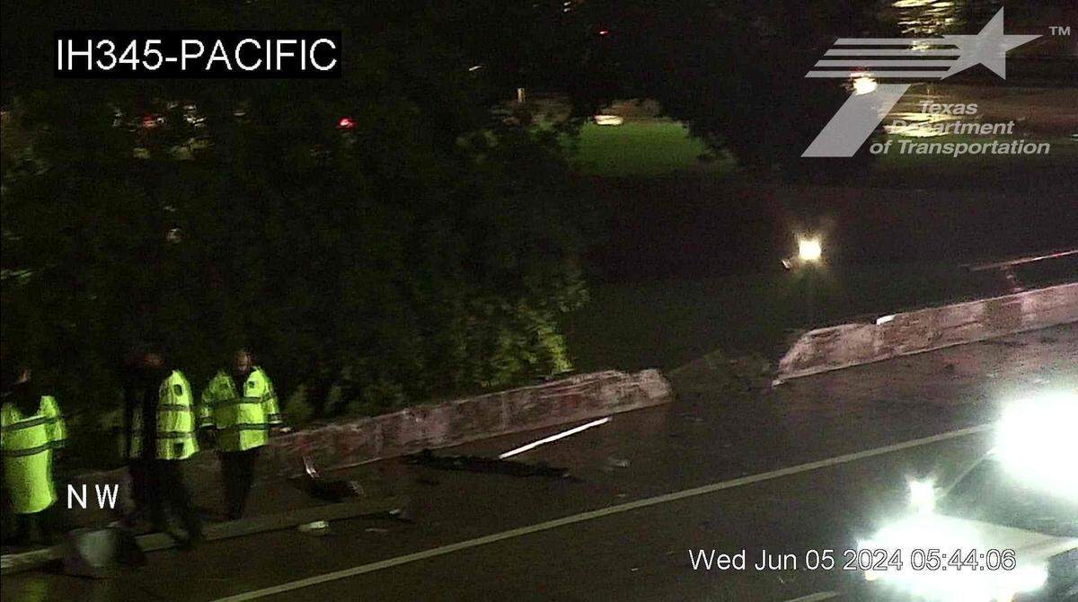A hole in a guardrail on U.S. 75/Interstate 345 in downtown Dallas shows where a tractor-trailer hit the bridge Wednesday morning, June 5, 2024.