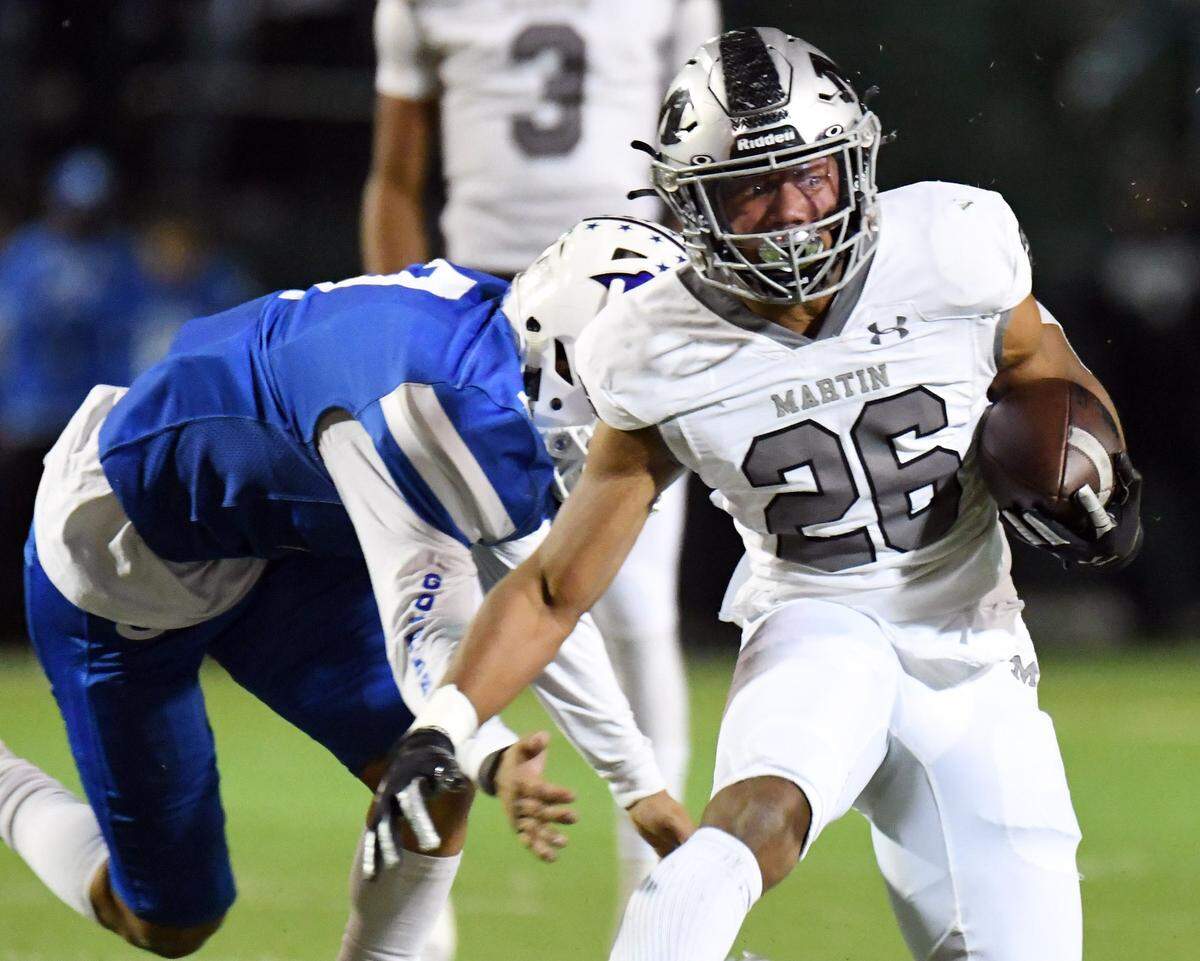 Arlington Martin’s Sergio Snider breaks away from Grand Prairie’s Albert Vasquez for a first down in the first quarter of their district 8-6A football game Friday, October 29, 2021 at the Gopher Warrior Bowl in Grand Prairie, Texas. Special/Bob Haynes
