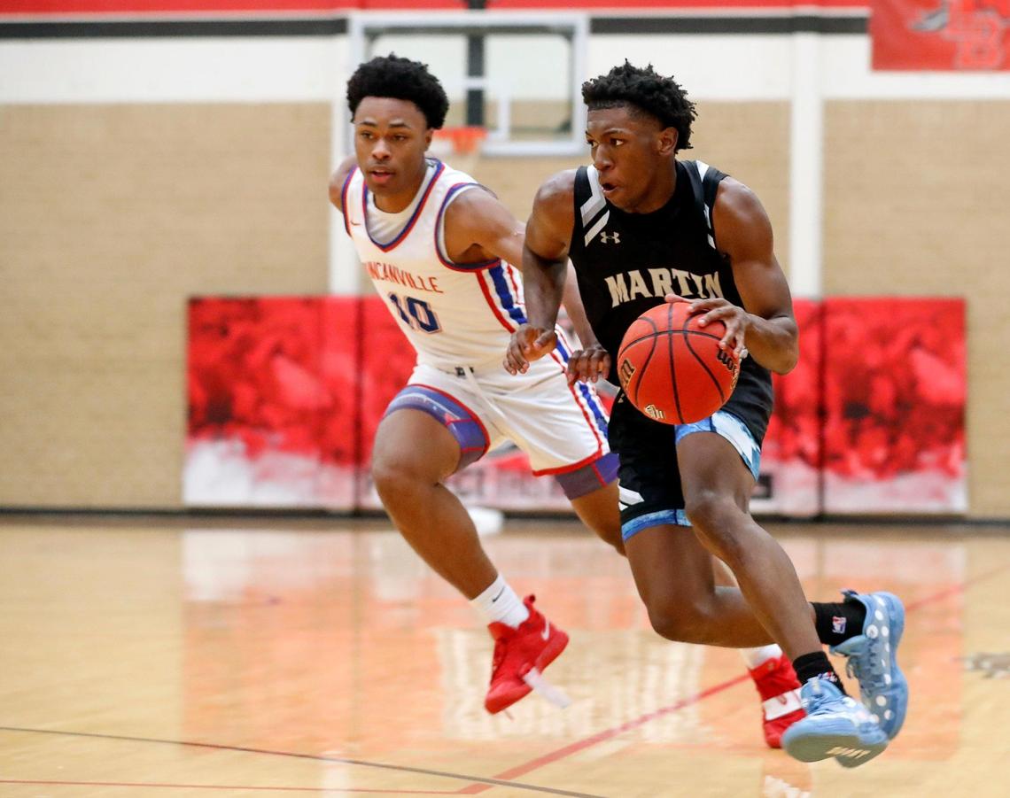 Martin guard Kordelius Jefferson (23) brings the ball down court ahead of Duncanville guard Rassaun Colier (10) during the Whataburger Basketball Tournament at Mansfield Legacy High School in Mansfield, Texas, Wednesday, Dec. 29, 2021. Duncanville defeated Arlington Martin 61-55. (Special to the Star-Telegram Bob Booth)