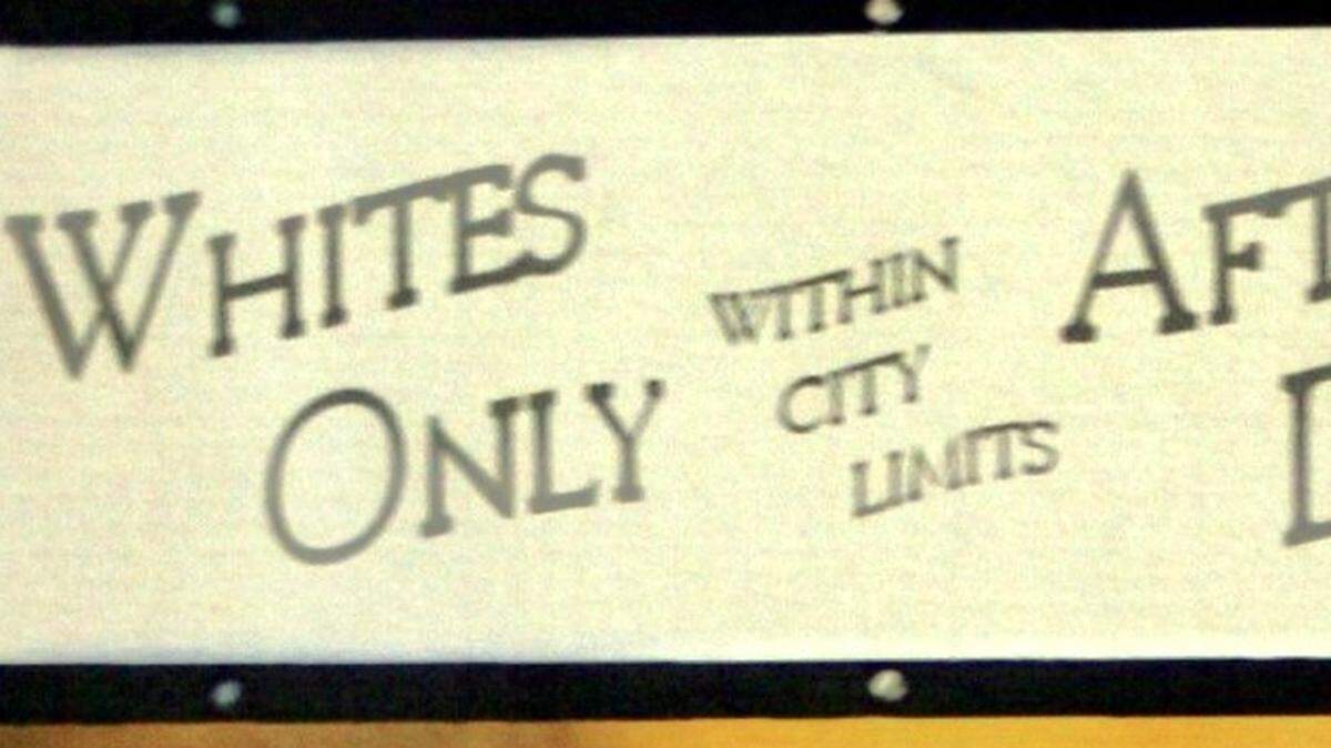 This sign from a Connecticut city is an example of “sundown signs” in America, redrawn for the cover of late author James Loewen’s “Sundown Towns.” The original is in the Harriet Tubman Museum in Macon, Georgia.