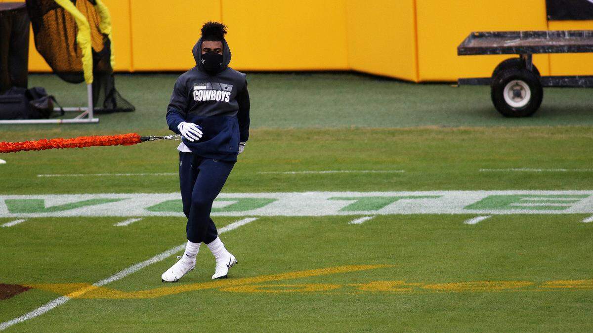 Dallas Cowboys running back Ezekiel Elliott (21) warms up in front of VOTE signage on the field before an NFL football game against the Washington Football Team, Sunday, Oct. 25, 2020 in Landover, Md. (AP Photo/Daniel Kucin Jr.)