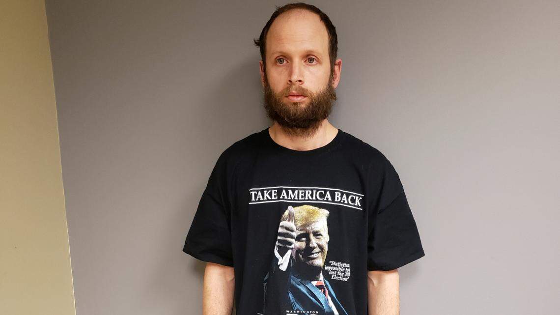 This undated photo provided by the United States Attorney’s Office, Northern District of Texas shows Garret Miller after he was arrested in Dallas. Miller didn’t speak to the law enforcement officers who arrested him on charges he stormed the U.S. Capitol in January, but the T-shirt he was wearing at his Dallas home that day sent a clear and possibly incriminating message. Miller’s shirt had a photograph of former President Donald Trump, and it said “Take America Back” and “I Was There, Washington D.C., January 6, 2021,” federal prosecutors noted in a court filing Monday, March 29, 2021.