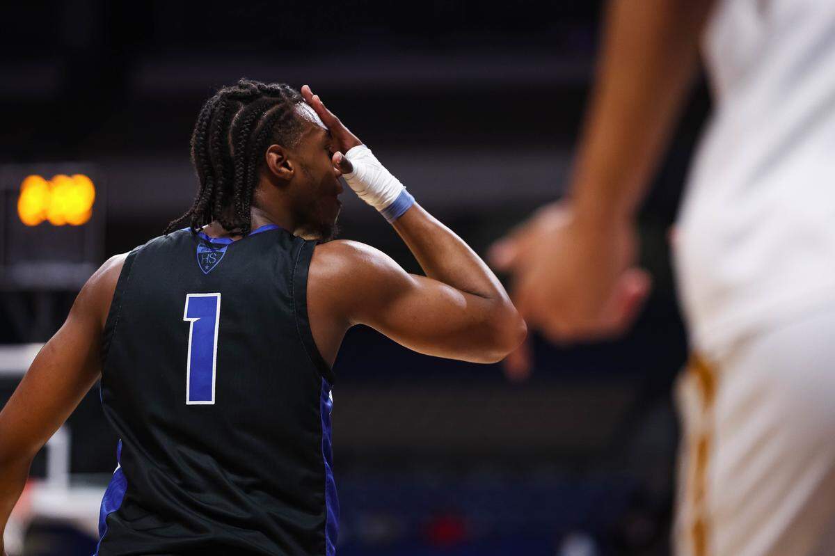 North Crowley forward Alex Barther II puts his hand on his face in celebration after making a 3-pointer in the Class 6A Division I state championship game against San Antonio Brennan on Saturday at the Alamodome in San Antonio.