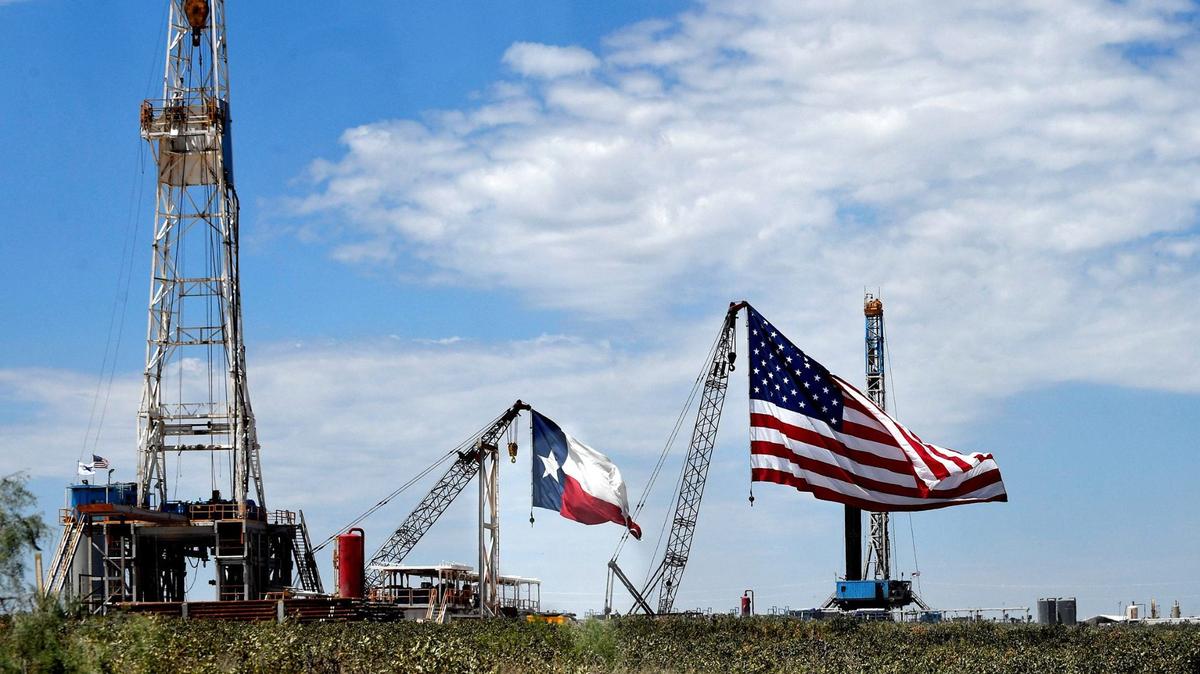An oversized Texas flag flies from a crane at Double Eagle Energy outside of Midland in 2020. West Texas oilmen Tim Dunn and Farris Wilks, both major Republican donors, have waded into a number of North Texas legislative races, including ones with May 28 primary runoffs.