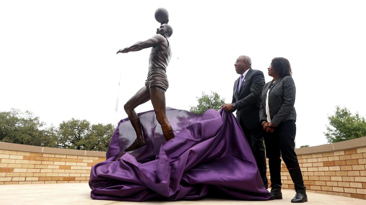 James Cash and his wife Clemmie unveil a statue of Cash in front of TCU’s Schollmaier Arena on Friday. Cash was the first Black student-athlete at TCU and first Black basketball player in the Southwest Conference.