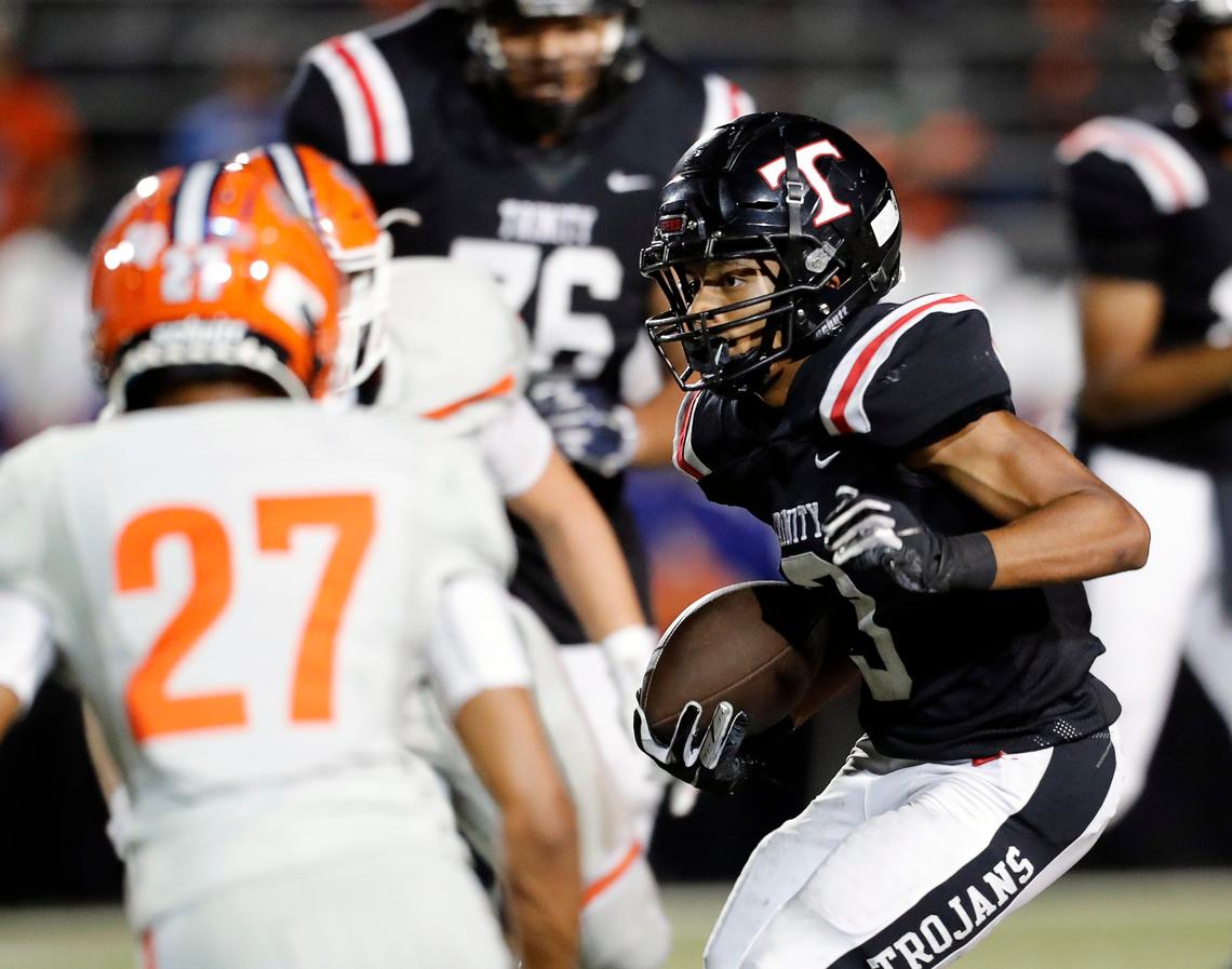 Trinity running back Zechariah Moore (3) attacks the middle of the line during the first half of a high school football game at Pennington Field in Bedford, Texas, Friday, Oct. 04, 2019. Trinity led 28-17 at the half. (Special to the Star-Telegram Bob Booth)