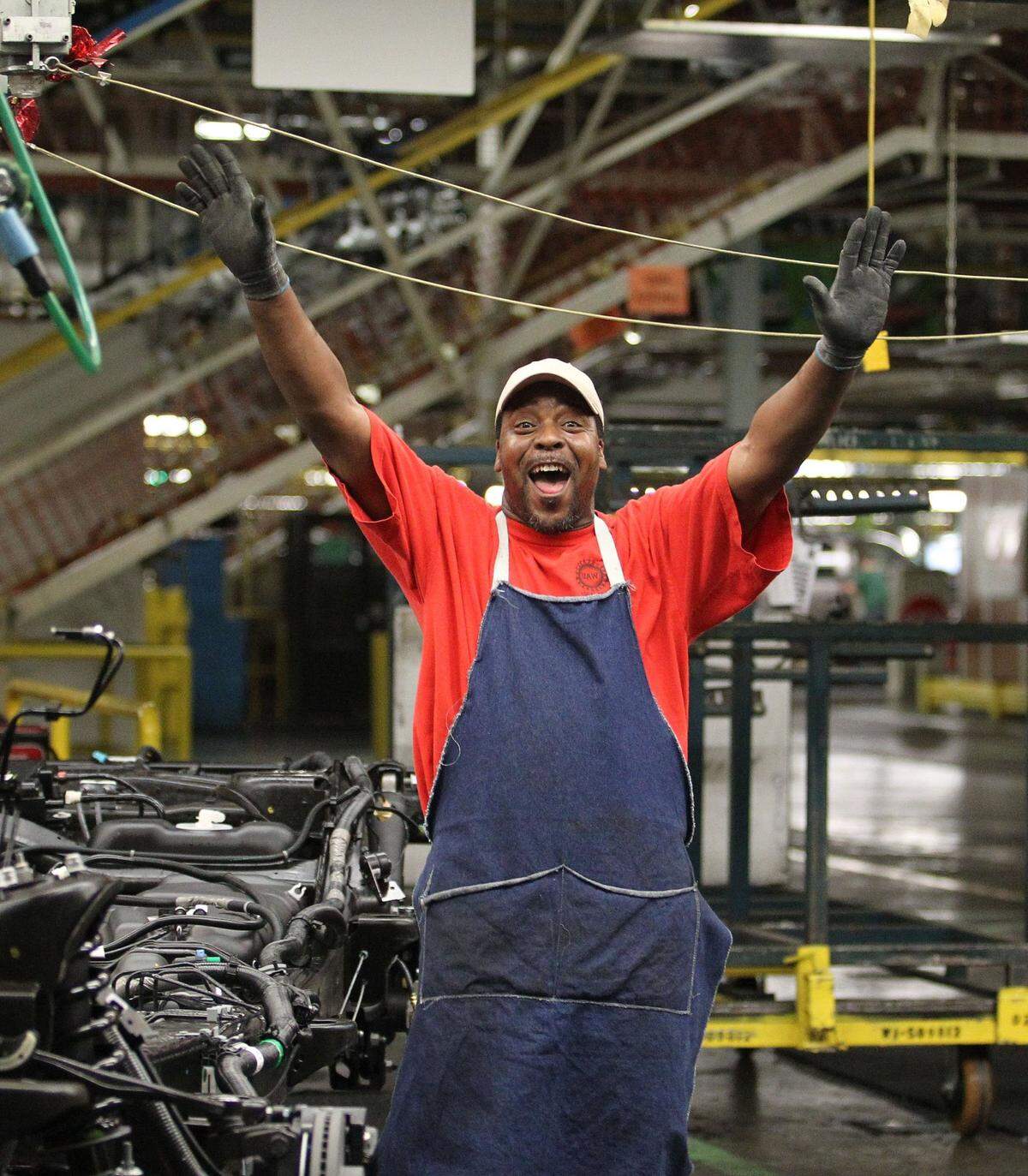 June 12, 2012: The UAW workers busy on the brake assembly line had waves and signs for guests touring the General Motors assembly plant in Arlington.