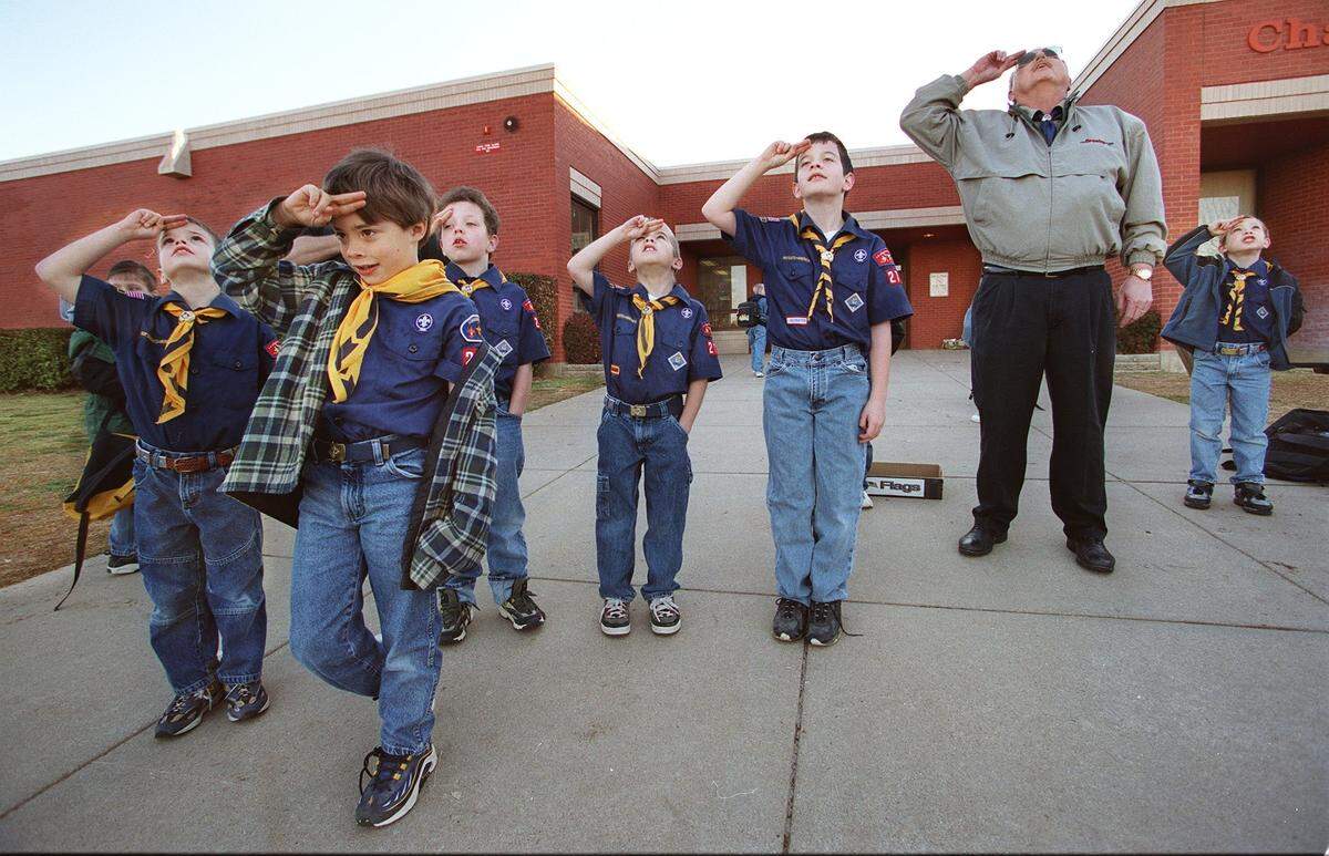 Feb. 8, 2000: Cub Scouts at Charlotte Anderson Elementary in Arlington salute as the flag is raised on the 90th anniversary of Scouting in the USA. From left, Chance Watkins, Andrew Haslam, Patrick Hayes, Tyler Temple, Steven Sutton, David Hayes and Danny Clark.