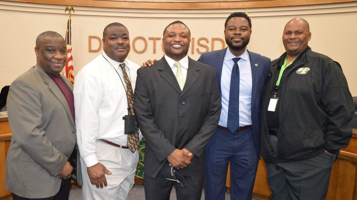 Claude Mathis, middle, was announced as the next DeSoto head football coach on Monday.