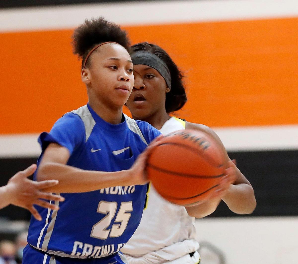 North Crowley center Maiyah Watkins (25) passes the ball to the perimiter during the second half of a 6A Region 1 Bi-district girls basketball game at Haltom High School in Haltom City, Texas, Friday, Feb. 12, 2021. North Crowley defeated Fossil Ridge 44-41. (Special to the Star-Telegram Bob Booth)