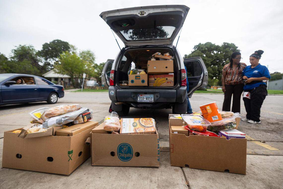Amani Latimer Burris, left, and Maria Echeverria organize boxes in a truck for Opal Lee to deliver groceries Sept. 1 at Community Food Bank in Fort Worth. Twice a month, Lee, with a couple of helpers, delivers grocery boxes to homebound people on her list.