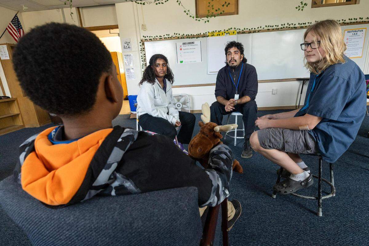 Omar Marquez, a restorative practices coach, helps Lyla Vanderstole, 14, Oliver Watson, 13, and Noah Lane, 12, to resolve a conflict in his classroom at Applied Learning Academy in Fort Worth on Wednesday, Nov. 29, 2023.