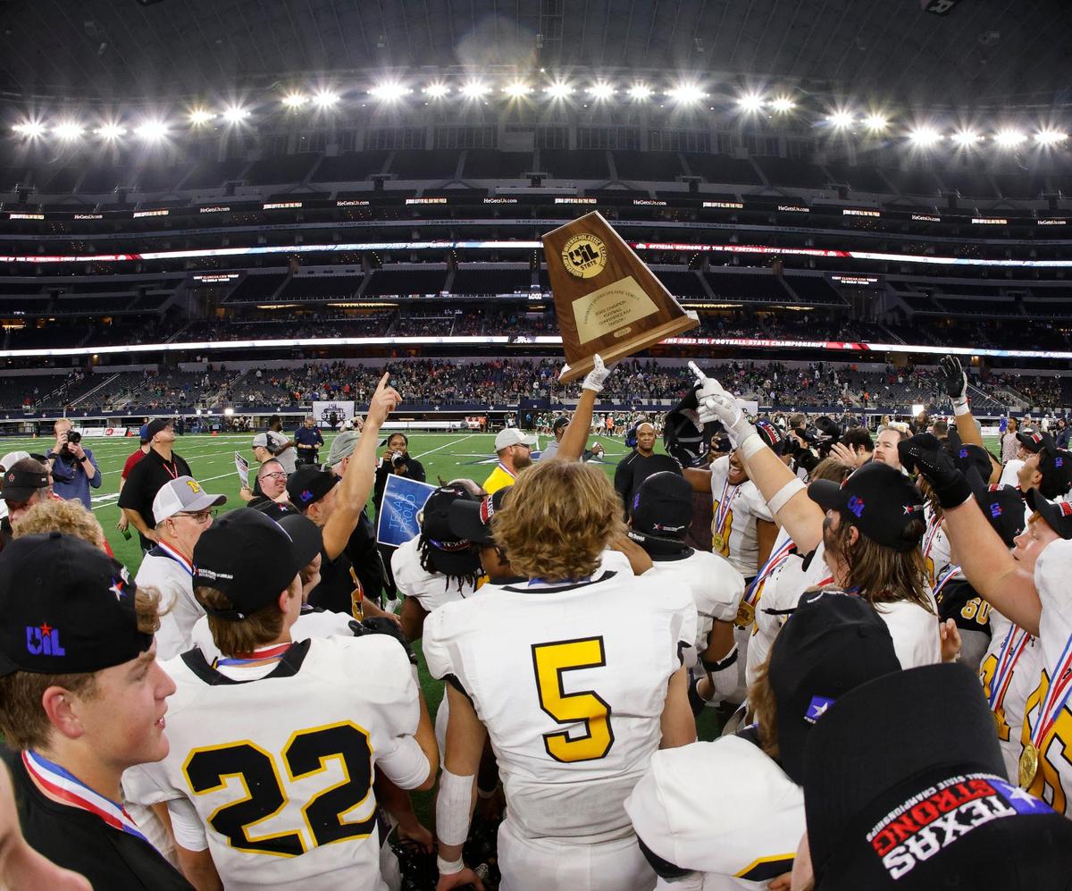 The Tigers hold up the UIL State Championship trophy after the Conference 3A Division 1 state championship football game at AT&T Stadium in Arlington, Texas, Thursday, Dec. 14, 2023.