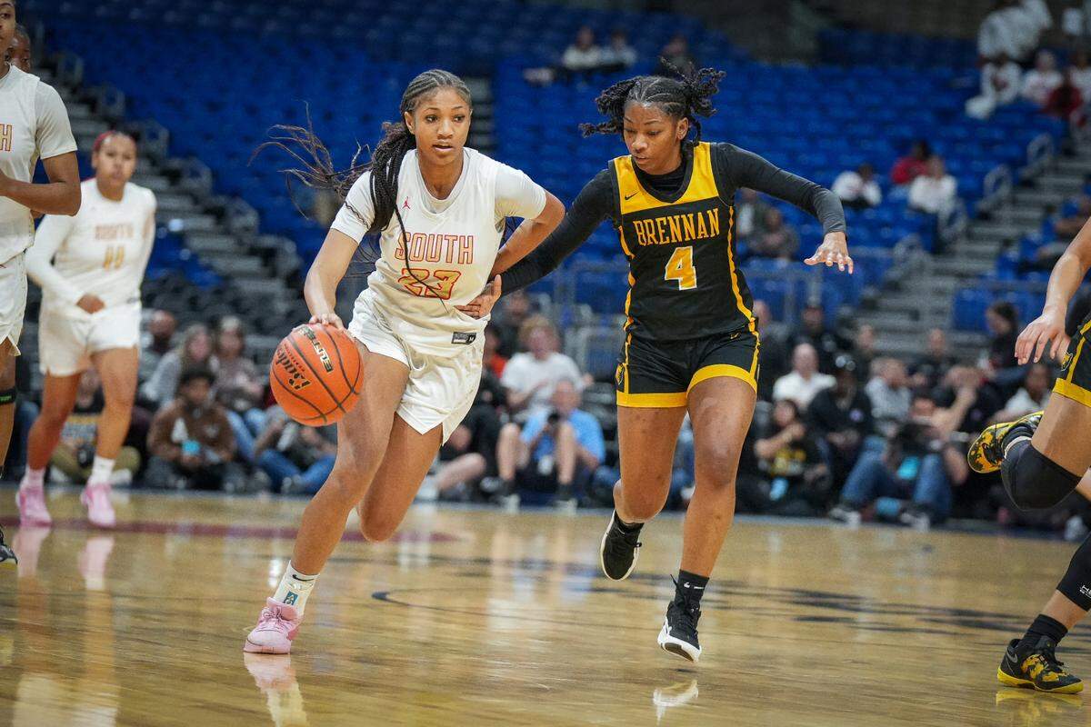 South Grand Prairie’s Taliyah Parker dribbles up court with San Antonio Brennan’s Tiara Louis chasing in a Class 6A state semifinal on Friday, March 1, 2024 at the Alamodome in San Antonio, Texas. SGP defeated Brennan 53-42.