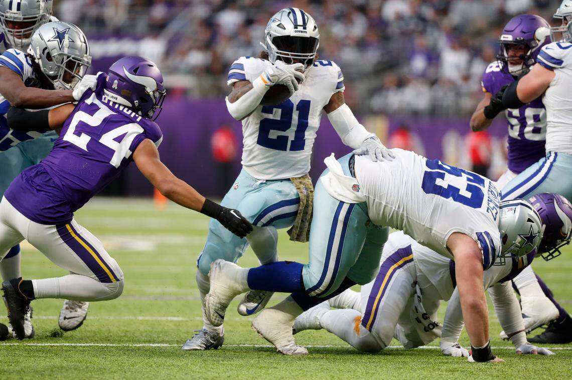 Dallas Cowboys running back Ezekiel Elliott (21) runs from Minnesota Vikings safety Camryn Bynum (24) during the first half of an NFL football game, Sunday, Nov. 20, 2022, in Minneapolis. (AP Photo/Bruce Kluckhohn)
