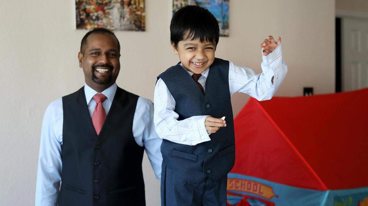 Hudson Moses, left, poses with his son, Kenneth, 4, who has autism, while they play at home. Hudson Moses says his son benefited from the help of a behavior therapist and connecting with resources through the organization Help Me Grow.