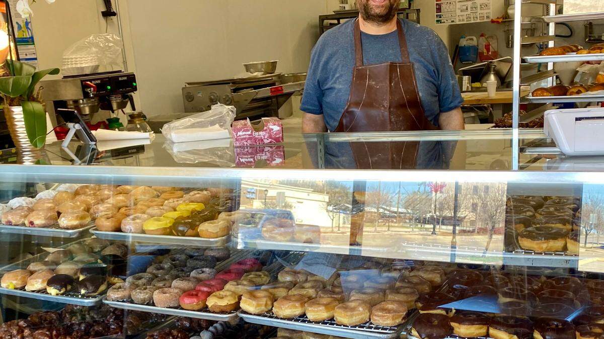 Haytham Mousa with a full cabinet at Mousa Donut in Fort Worth. (He took his mask down for the photo,)