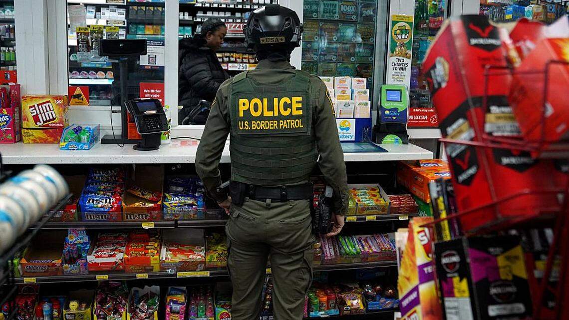 CHARLOTTE, NORTH CAROLINA - NOVEMBER 17: A U.S. Border Patrol agent talks with a gas station worker on November 17, 2025 in Charlotte, North Carolina. Federal agents are carrying out "Operation Charlotte's Web," an ongoing immigration enforcement surge across the Charlotte region (Photo by Ryan Murphy/Getty Images)