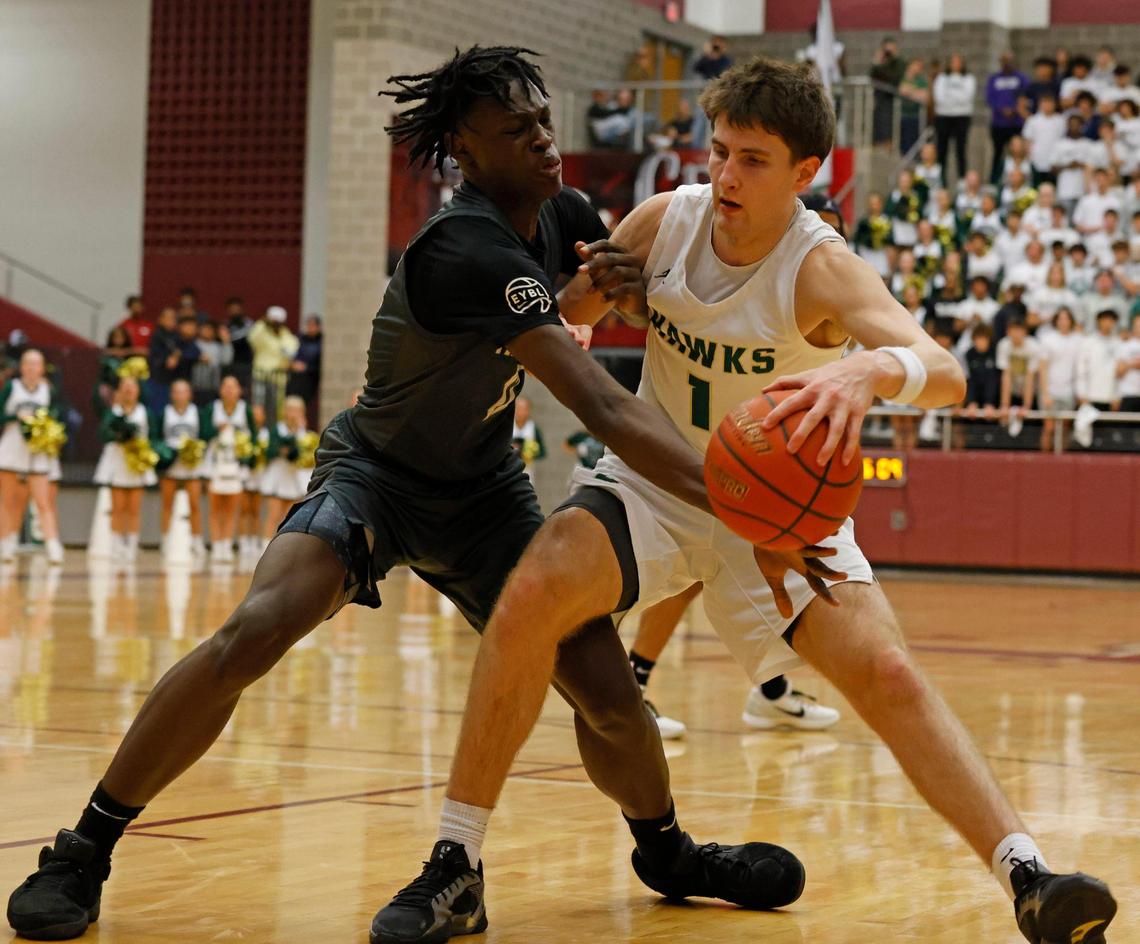 Frisco Heritage forward Bryson Howard (12) reaches in on Birdville forward Sawyer Dotson (1) during the first half of the UIL 5A state semifinal playoff basketball playoff game at Lewisville High School in Lewisville Texas, Tuesday, Mar. 04, 2025.