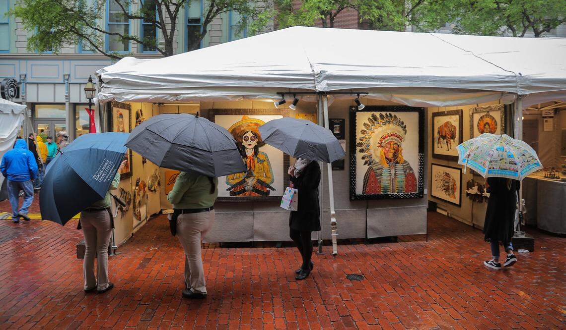 The crowd was smaller than normal Saturday but determined arts lovers brought their rain gear and umbrellas and braved a rainy day at Main Street Fort Worth Arts Festival.