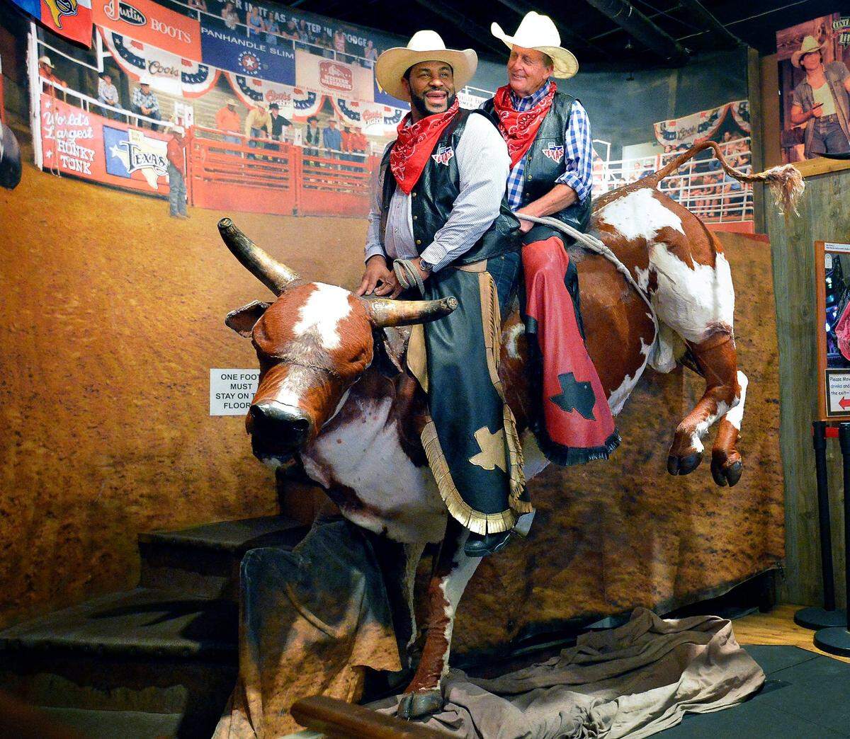 May 1, 2017: Former NFL great Jerome Bettis, left, and golfer Fred Funk take a ride on the bull after learning to line dance at Billy Bob’s Texas.