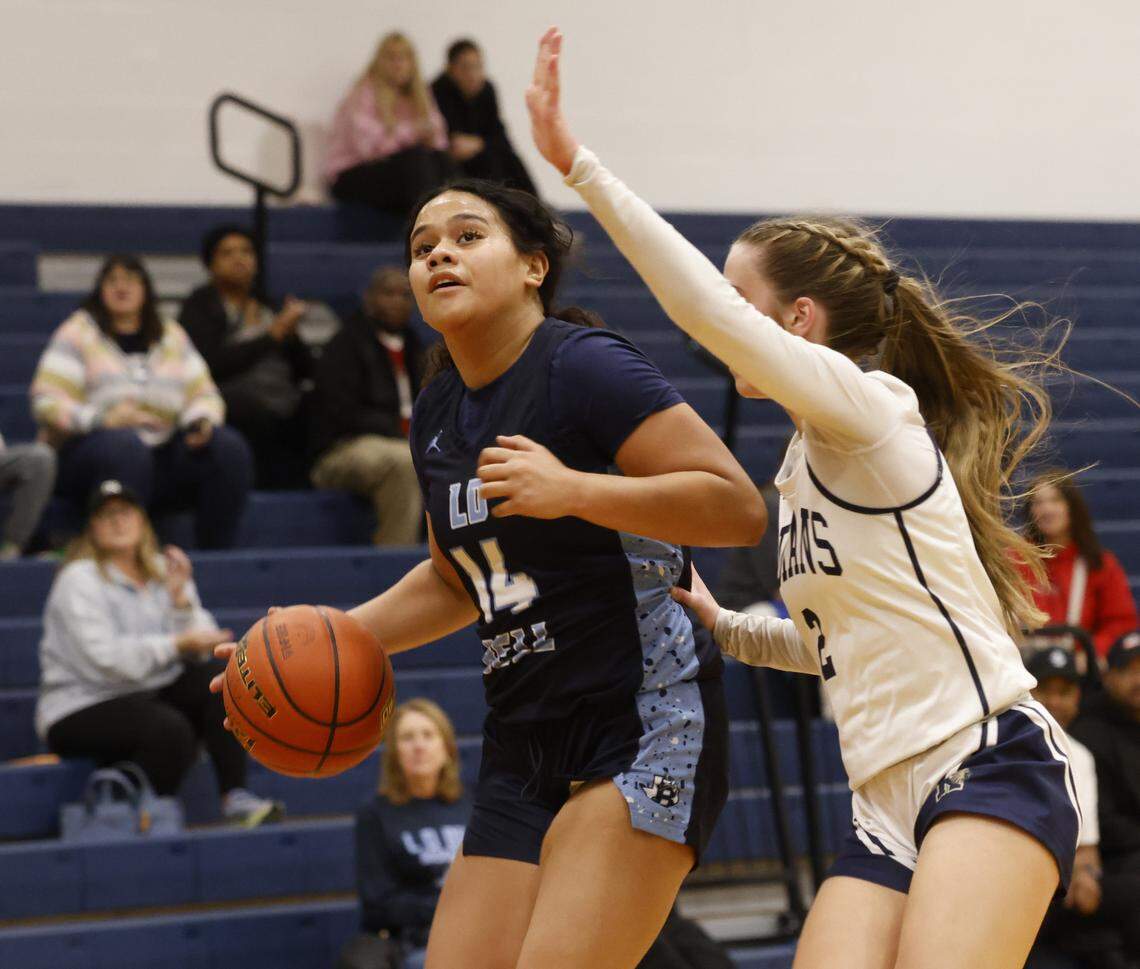 L.D. Bell guard Marleigh Vea (14) gets a look defended by Keller point guard Mia Arnold (2) during the first half of a UIL girls basketball game between L.D. Bell and Keller at Keller High School in Keller, Texas, Friday Jan. 16, 2026