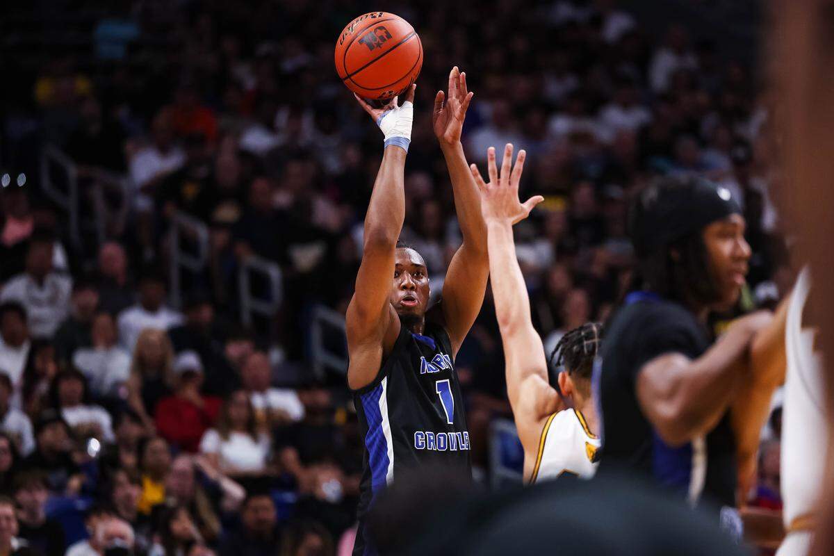 North Crowley forward Alex Barther II (1) attempts a three pointer over an outreached hand of a San Antonio Brennan defender in the Class 6A Division I state championship at The Alamodome in San Antonio, Texas, March 14, 2026.