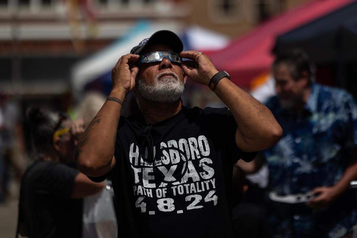 Hillsboro resident Charles Eaton puts on his eclipse glasses to take a look at the Great North American Eclipse in Hillsboro on Monday, April 8, 2024.