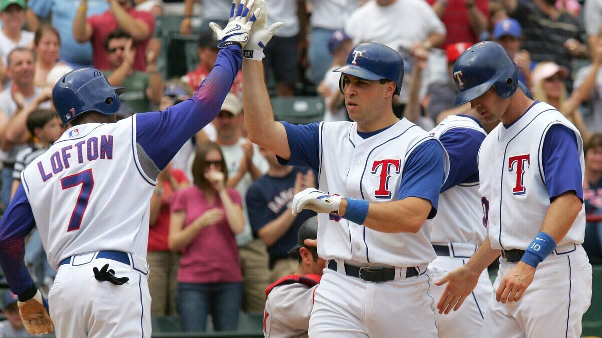 Kenny Lofton, left, of the Texas Rangers gives Mark Teixeira a high five after Teixeira’s three-run homer against the Boston Red Sox in a 2007 game in Arlington. Teixeira announced Thursday that he is running for Congress.