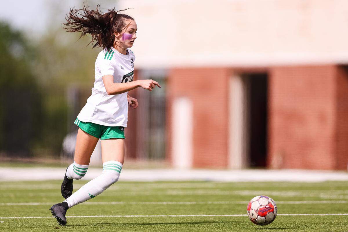 Southlake Carroll defender Berklee McCombs (21) dribbles the ball up the pitch against Forney in a UIL Class 6A Division 2 girls soccer state semifinal on Saturday, April 4, 2026, at Memorial Stadium in Mesquite, Texas.