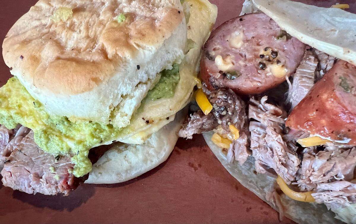 A brisket biscuit with poblano sauce and a breakfast taco with brisket and sausage at Hurtado.