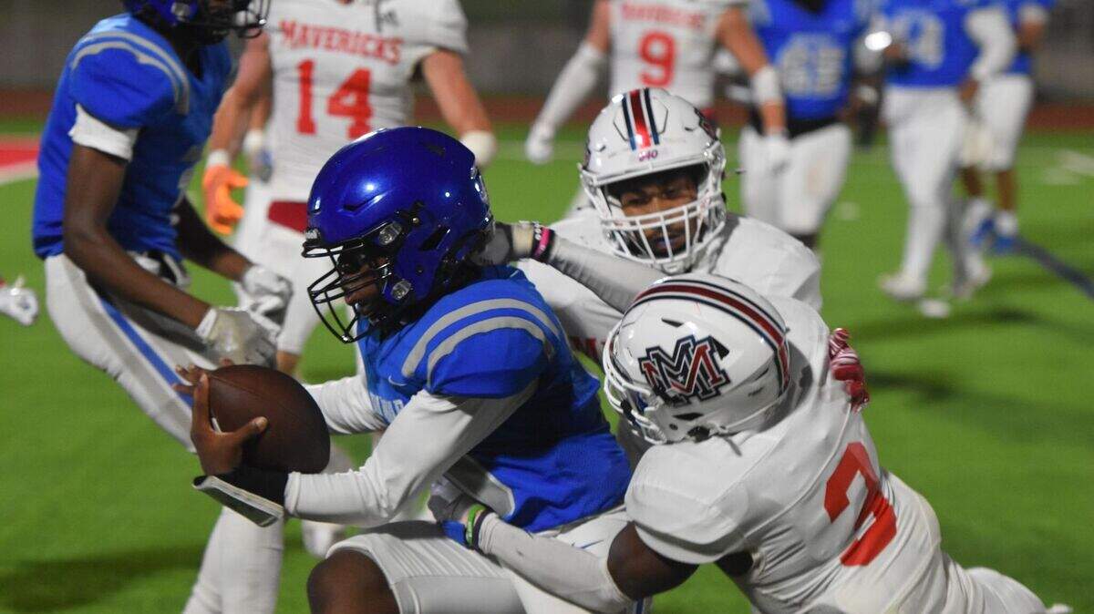 Fort Worth Dunbar’s Bryce Allen (10) fights for yardage against Wichita Falls Memorial during a high school football game at Clark Stadium in Fort Worth, Texas Thursday, September 12, 2024. Wichita Falls Memorial won 55-27.