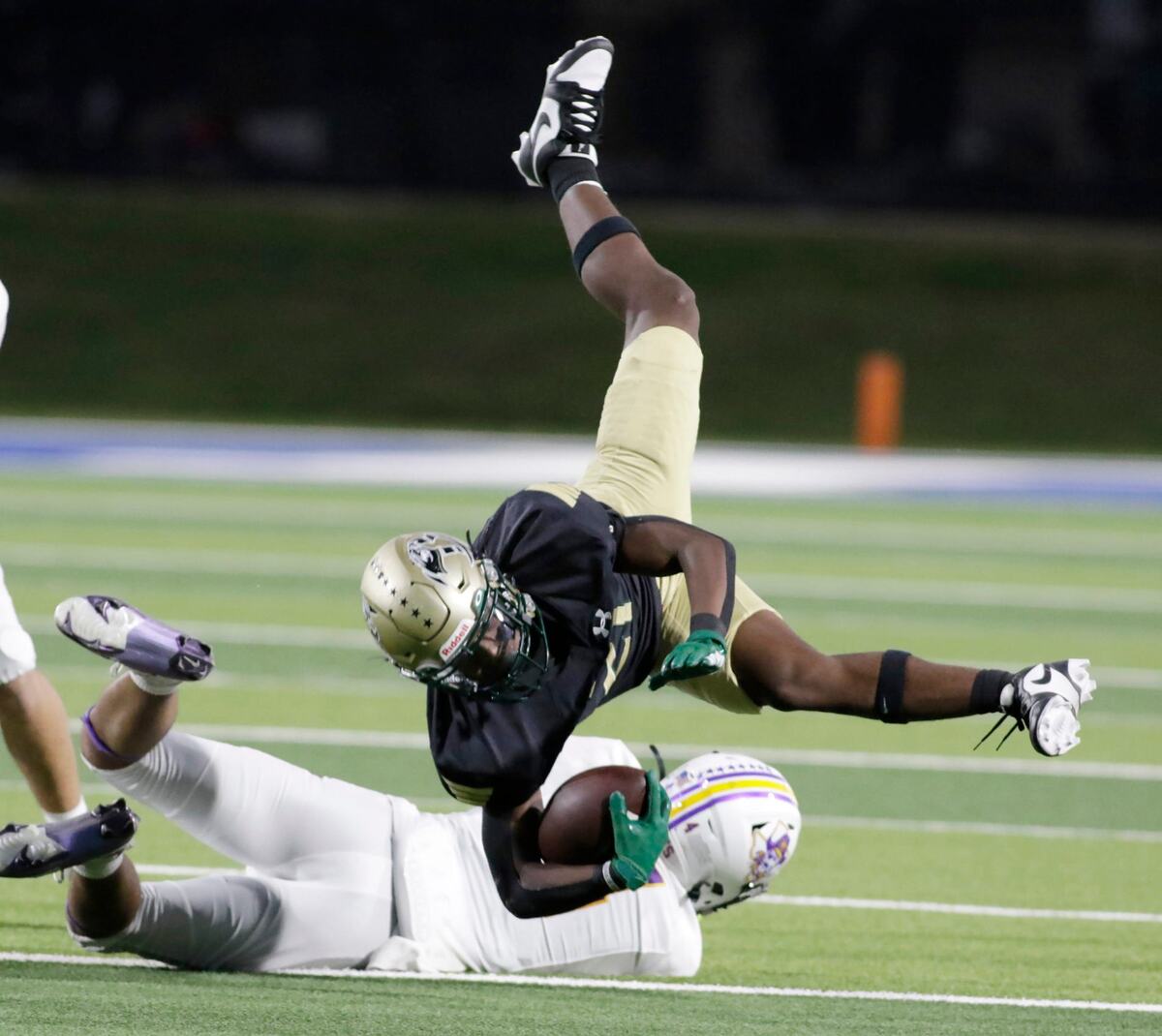 Birdville’s Anthony White is upended by Grandbury’s Tahj Clayton during their game Thursday night at Birdville Athletic Center. JOHN ROWLAND